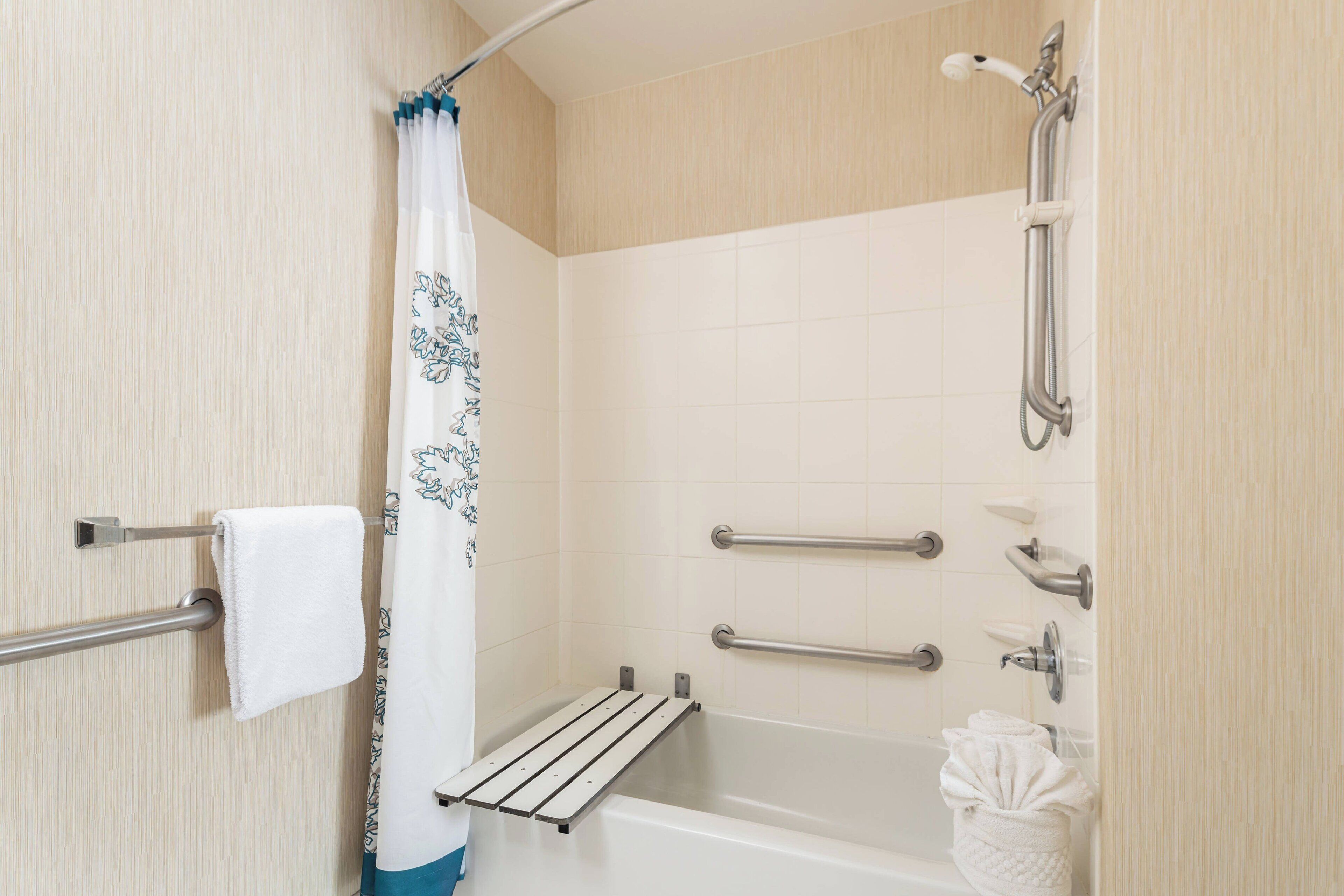 combined shower/bathtub, designer toiletries, hair dryer, towels