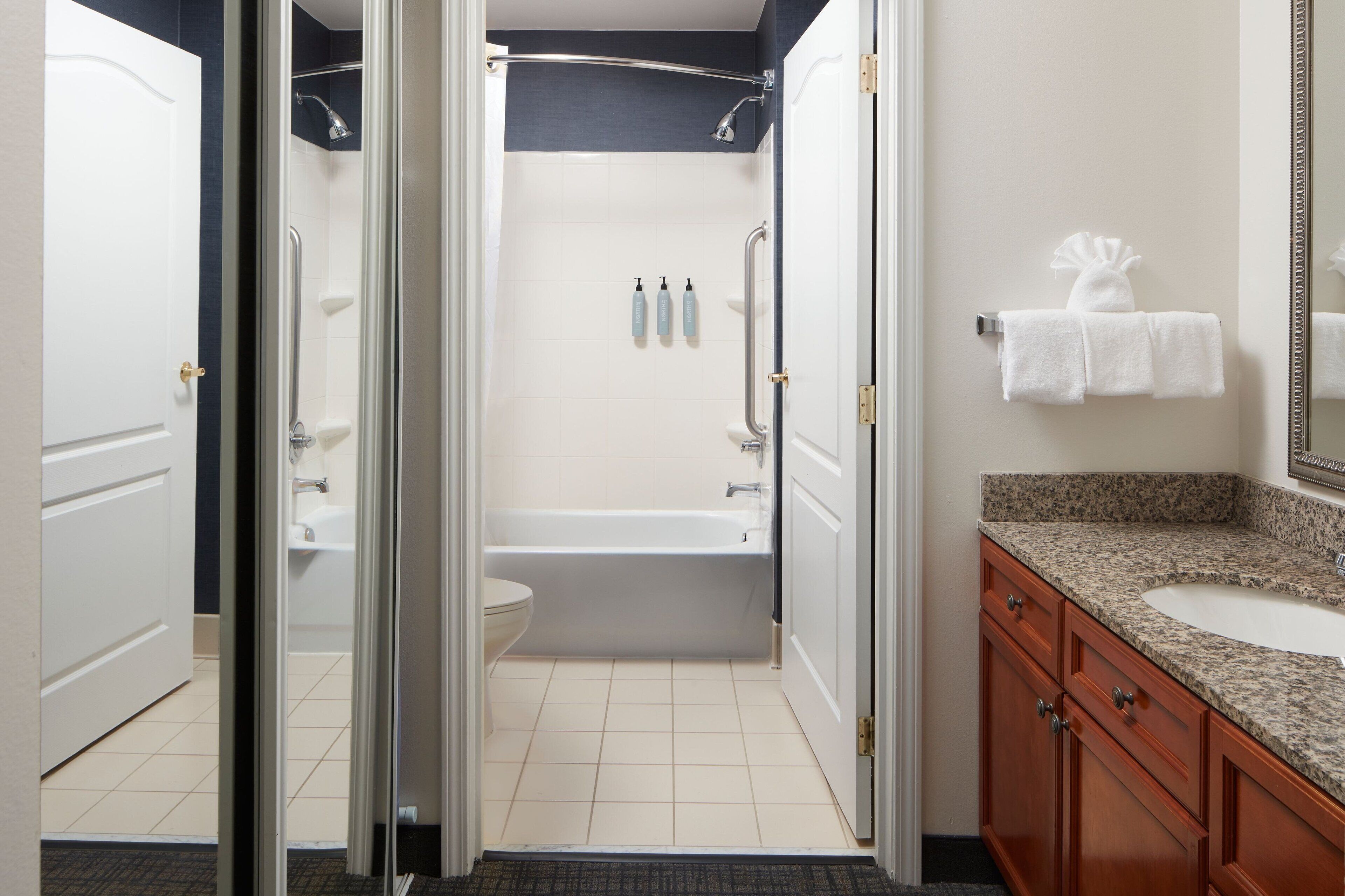 combined shower/bathtub, designer toiletries, hair dryer, towels