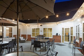 An outdoor patio with a grill, seating, and string lights. - Residence Inn by Marriott Manassas Battlefield Park (Manassas)