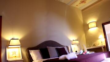 A hotel room with a bed, bedside lamps, a nightstand, and a mirror.