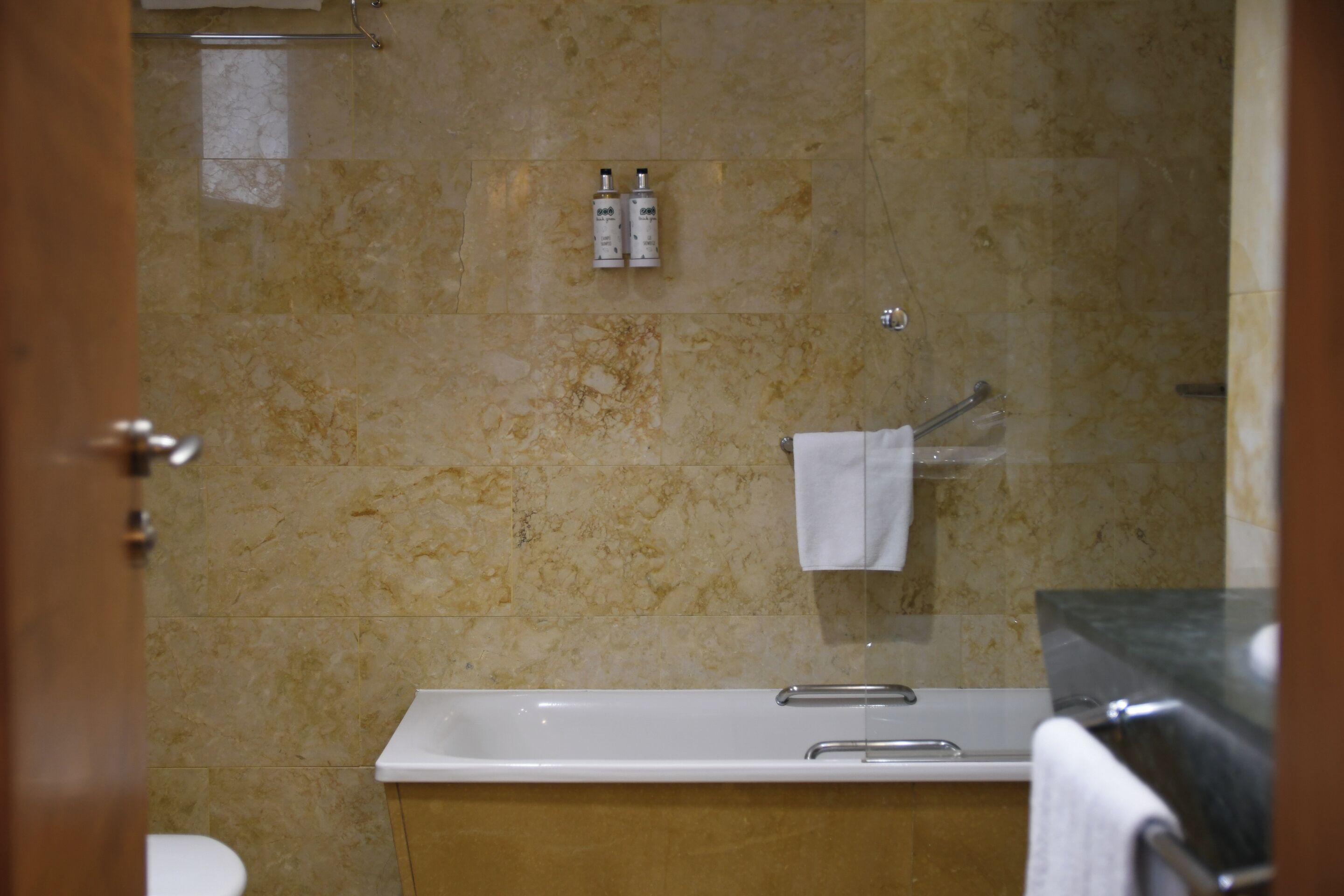 A bathroom with a bathtub, a toilet, and a shower area.