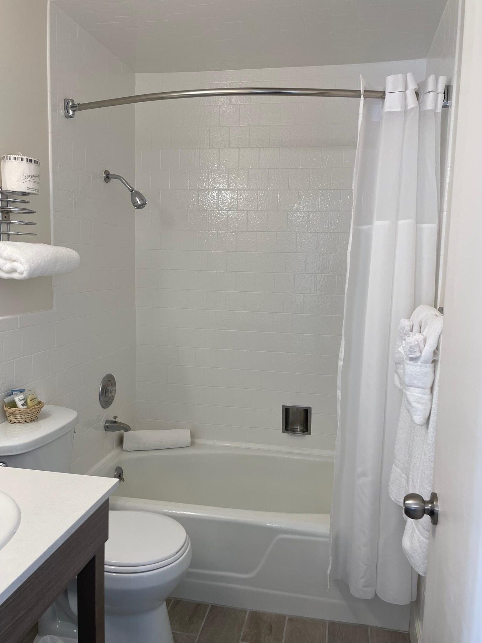 A bathroom with a bathtub, toilet, and sink.