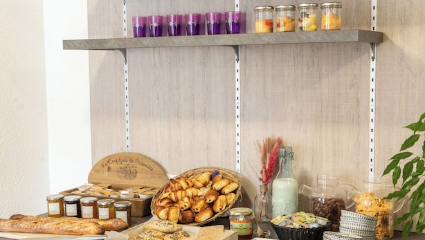 A breakfast buffet with various pastries, breads, and condiments. - Brit Hotel Tours Nord (Tours)