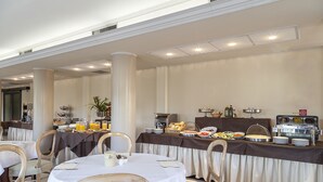 A breakfast buffet with various food items and a coffee station. - Grand Hotel Bonanno (Pisa)