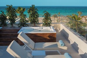 Een privéstrand, wit zand, ligstoelen aan het strand, parasols