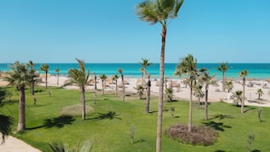 A beach resort with palm trees, a sandy beach, and a clear blue sky. - Iberostar Selection Eolia Djerba (Djerba Midun)