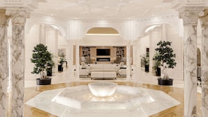 A luxurious lobby with marble columns, a central seating area, and a decorative fountain. - Iberostar Selection Eolia Djerba (Djerba Midun)