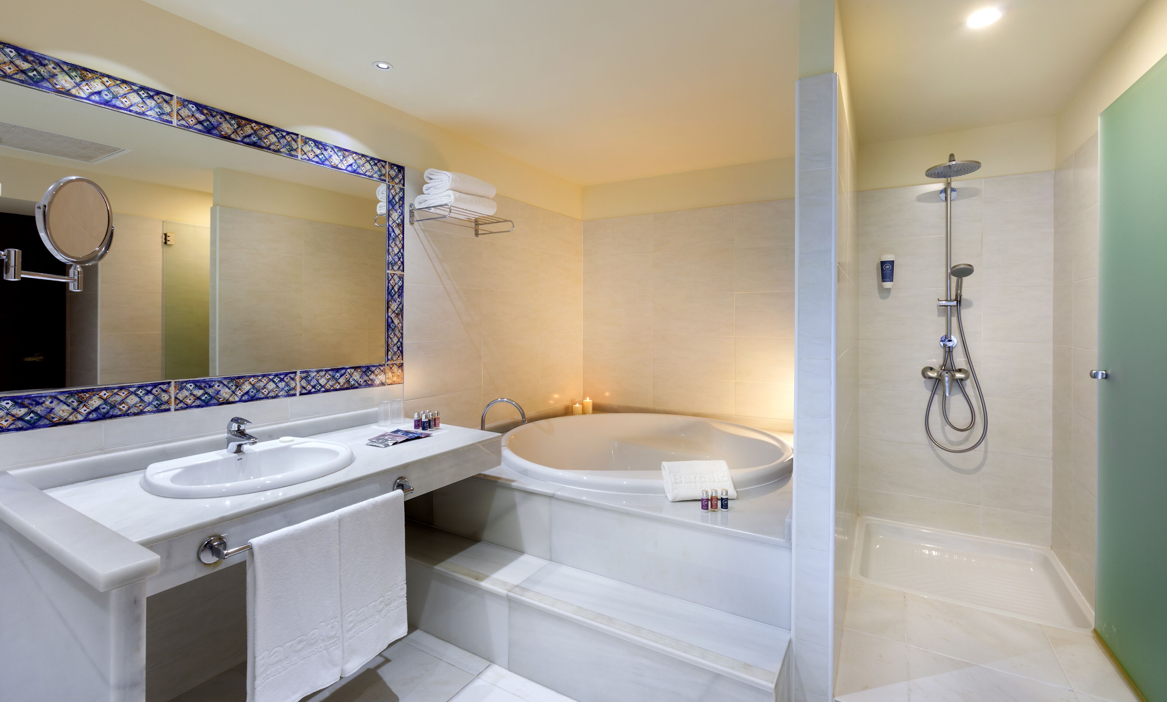 A modern bathroom with two sinks, a large bathtub, and a walk-in shower.