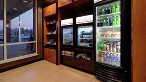 A store interior with refrigerated display cases labeled "market" and shelves stocked with various products. - Fairfield Inn & Suites by Marriott Wausau (Schofield)