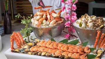 A seafood platter with various shellfish and crab legs, arranged on a bed of ice.