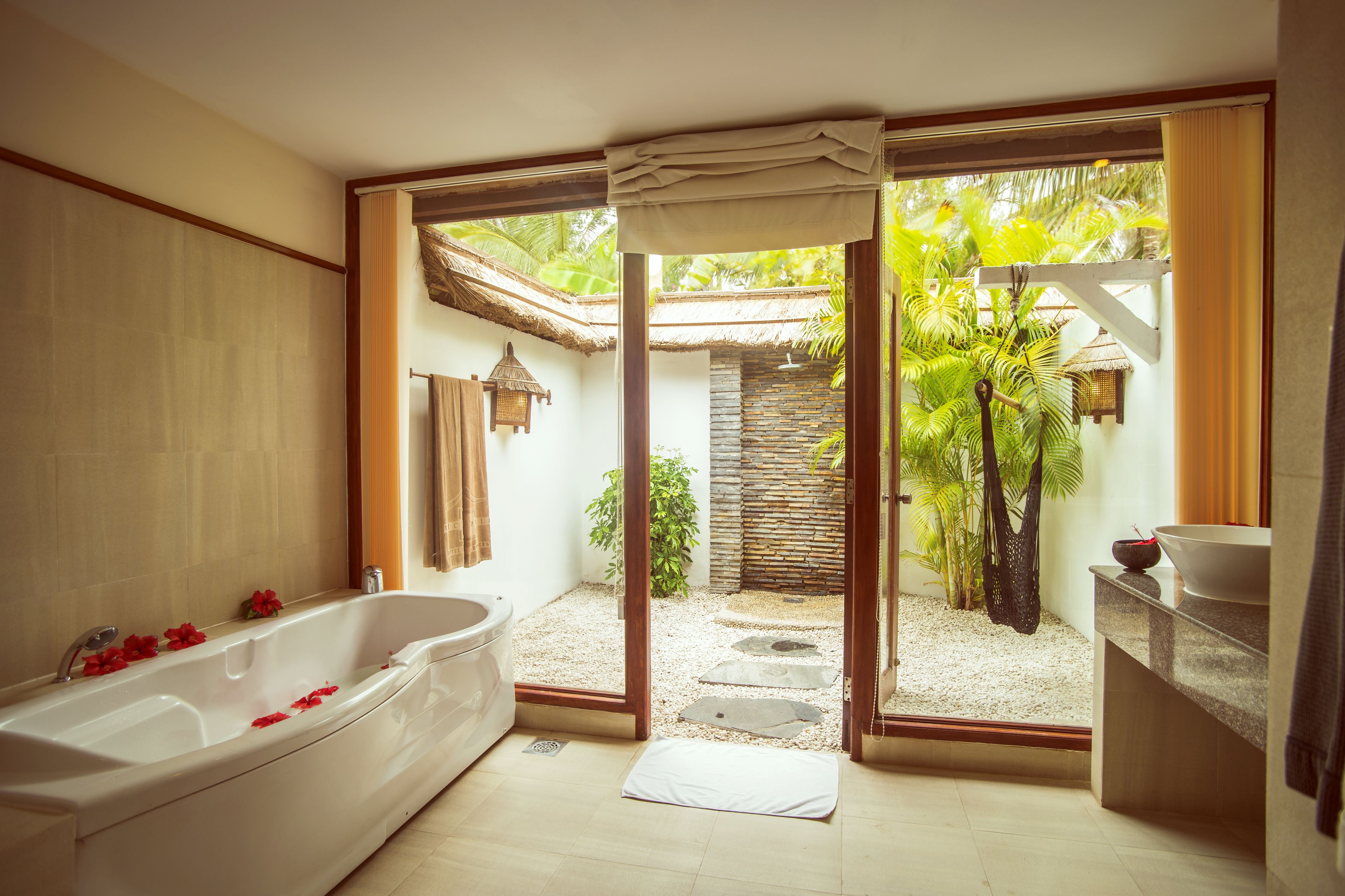 A bathroom with a bathtub, a shower, and a sink.