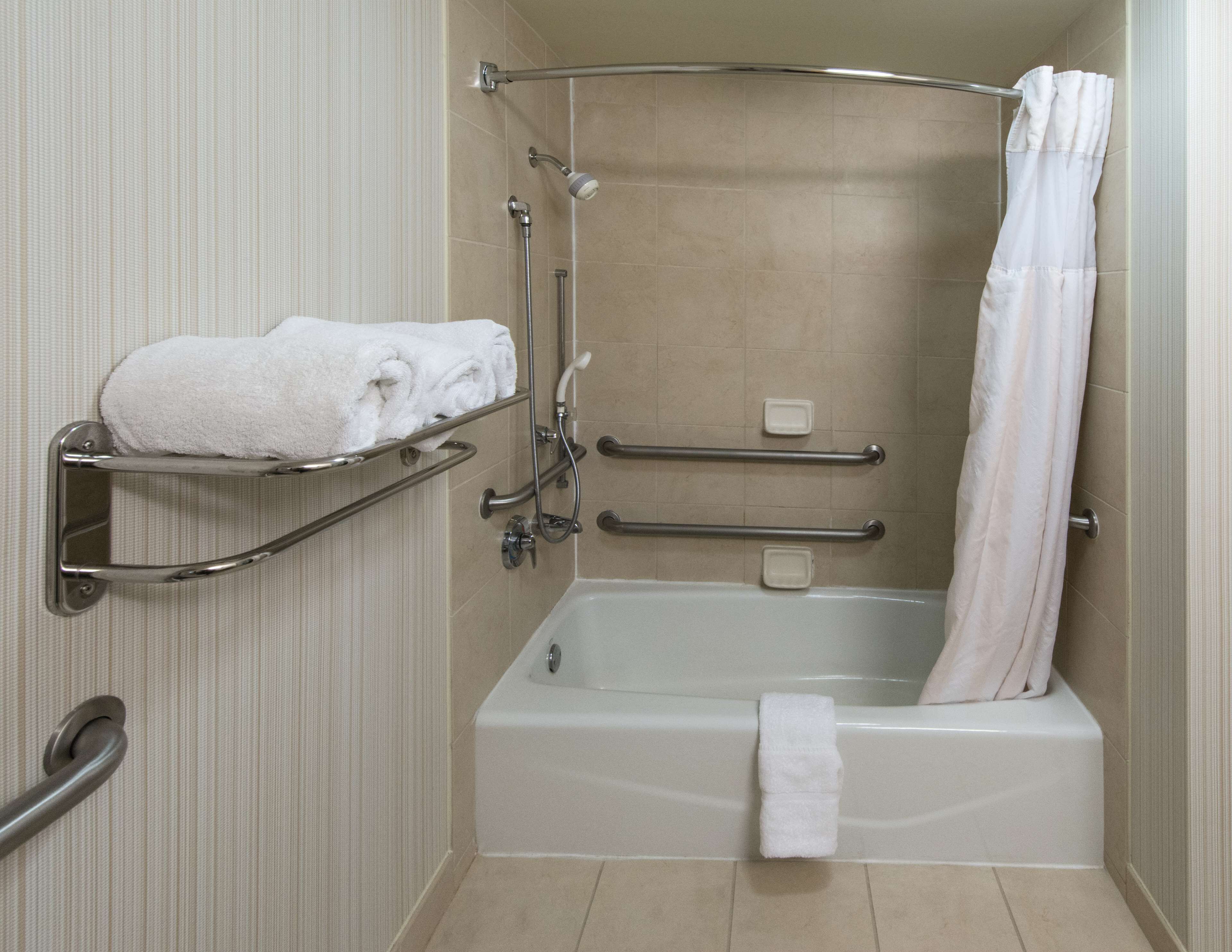 combined shower/bathtub, designer toiletries, hair dryer, towels