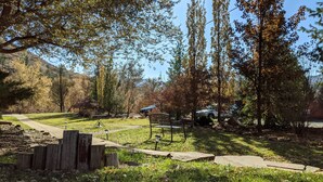 A park with a paved path, benches, and trees. - Stone Mountain Lodge and Cabins (Lyons)