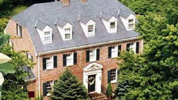 A large brick house with a symmetrical facade, multiple windows, and a central entrance with a decorative door. - Magnolia Manor B&B Inn (Williamsburg)