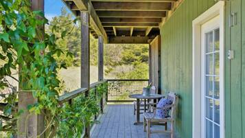 Relax on the covered porch with a view of the surrounding landscape.