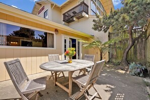 Enjoy outdoor dining and socializing on the spacious balcony with a round table and comfortable seating for six.
