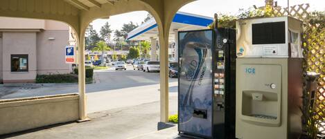 A gas station with a self-service drink dispenser and an ice dispenser.