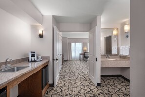 A hotel bathroom with a sink, mirror, and towel rack. - Holiday Inn Stevens Point - Convention Ctr by IHG (Stevens Point)