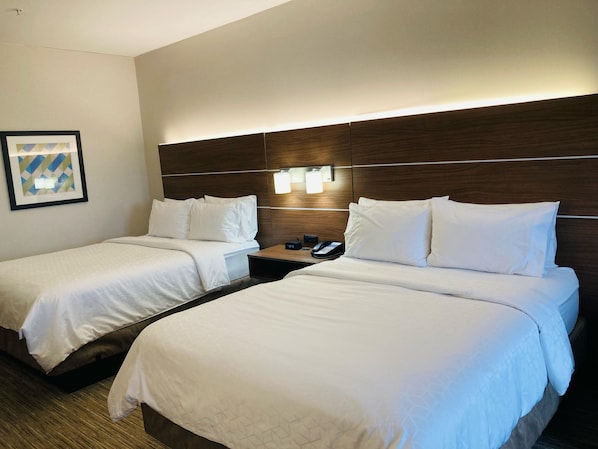 A hotel room with two beds, a nightstand with a phone, and a wall-mounted light fixture. - Holiday Inn Express & Suites Abilene by IHG (Abilene)