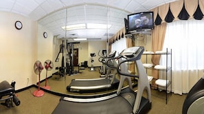 A gym with exercise equipment, a treadmill, and a television on the wall. - Holiday Inn Express & Suites Abilene by IHG (Abilene)