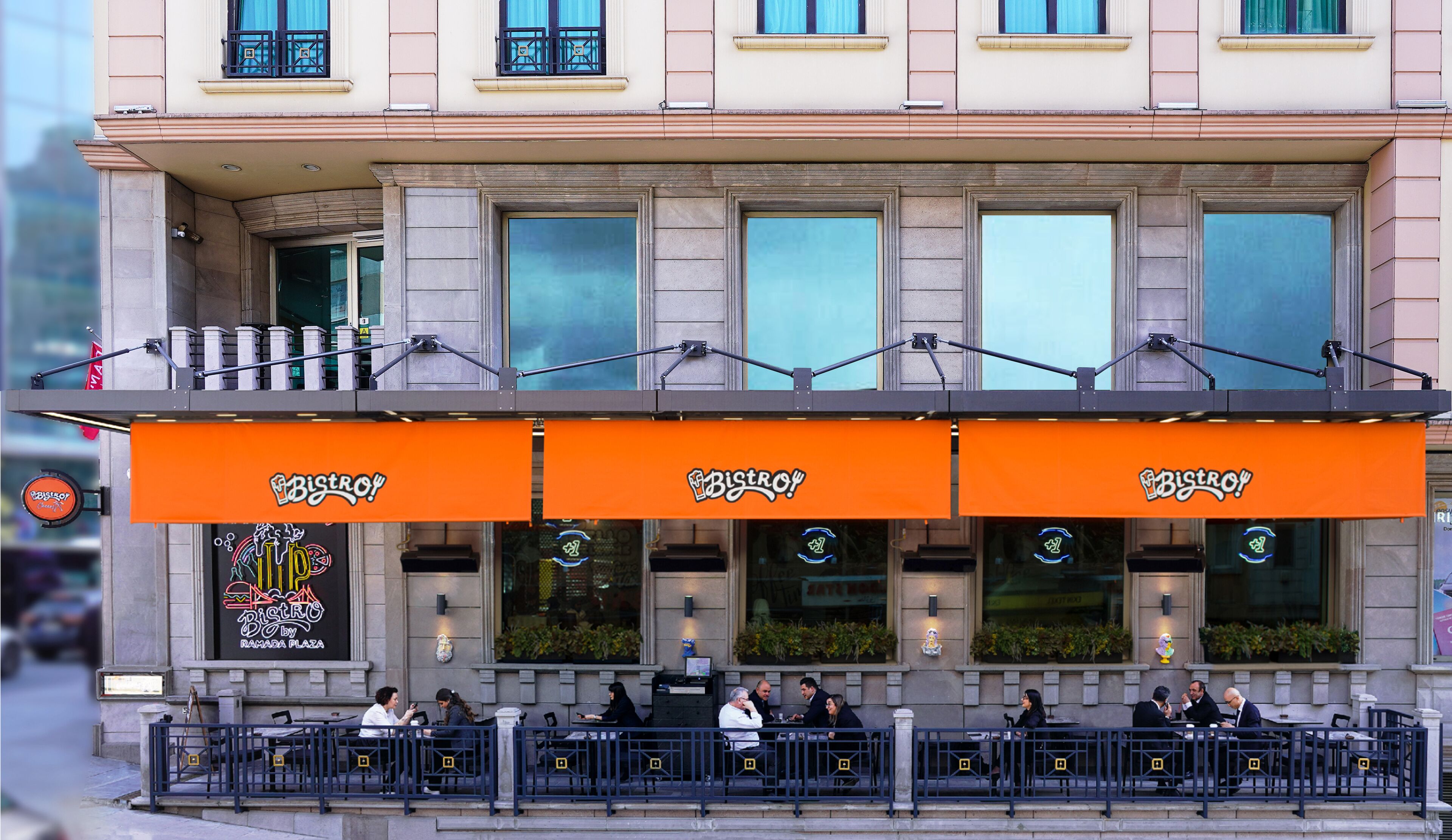 A restaurant with outdoor seating, a balcony, and a sign reading "Bistro".