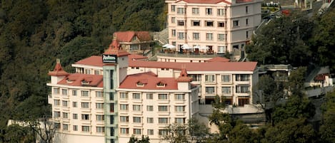 Experience the charm of a traditional hotel with a central courtyard and lush surroundings.