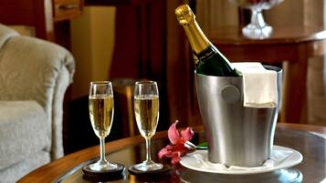 A table with two champagne flutes and a champagne bottle in a bucket.