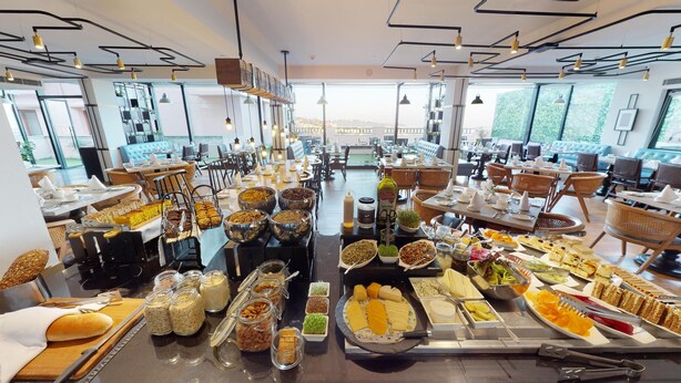 A buffet setup with various food items and utensils.