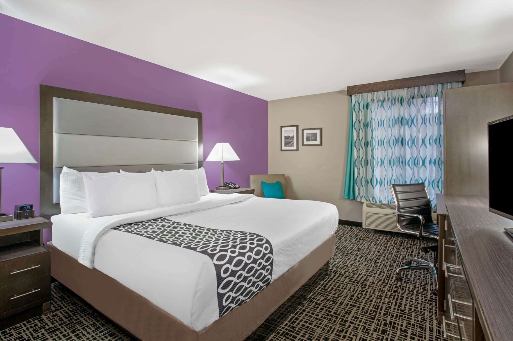 Premium bedding, desk, laptop workspace, blackout drapes