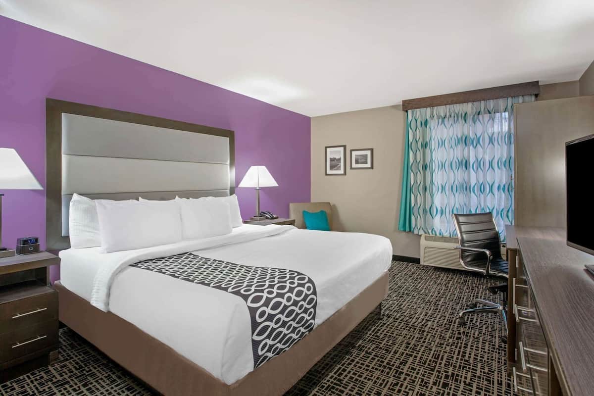 Premium bedding, desk, laptop workspace, blackout drapes