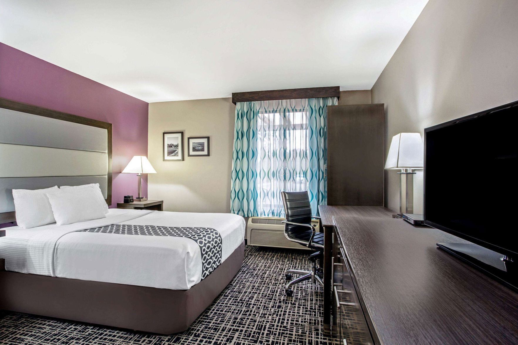 Premium bedding, desk, laptop workspace, blackout drapes