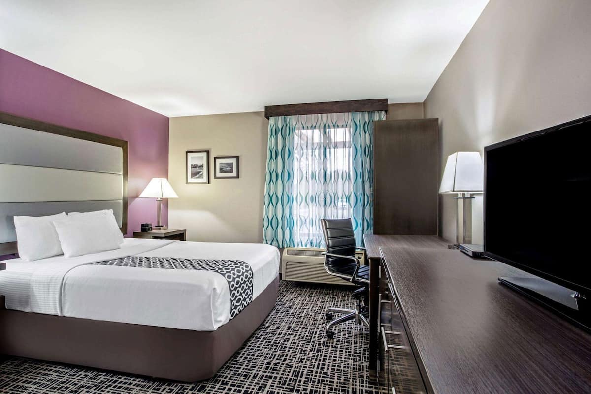 Premium bedding, desk, laptop workspace, blackout drapes