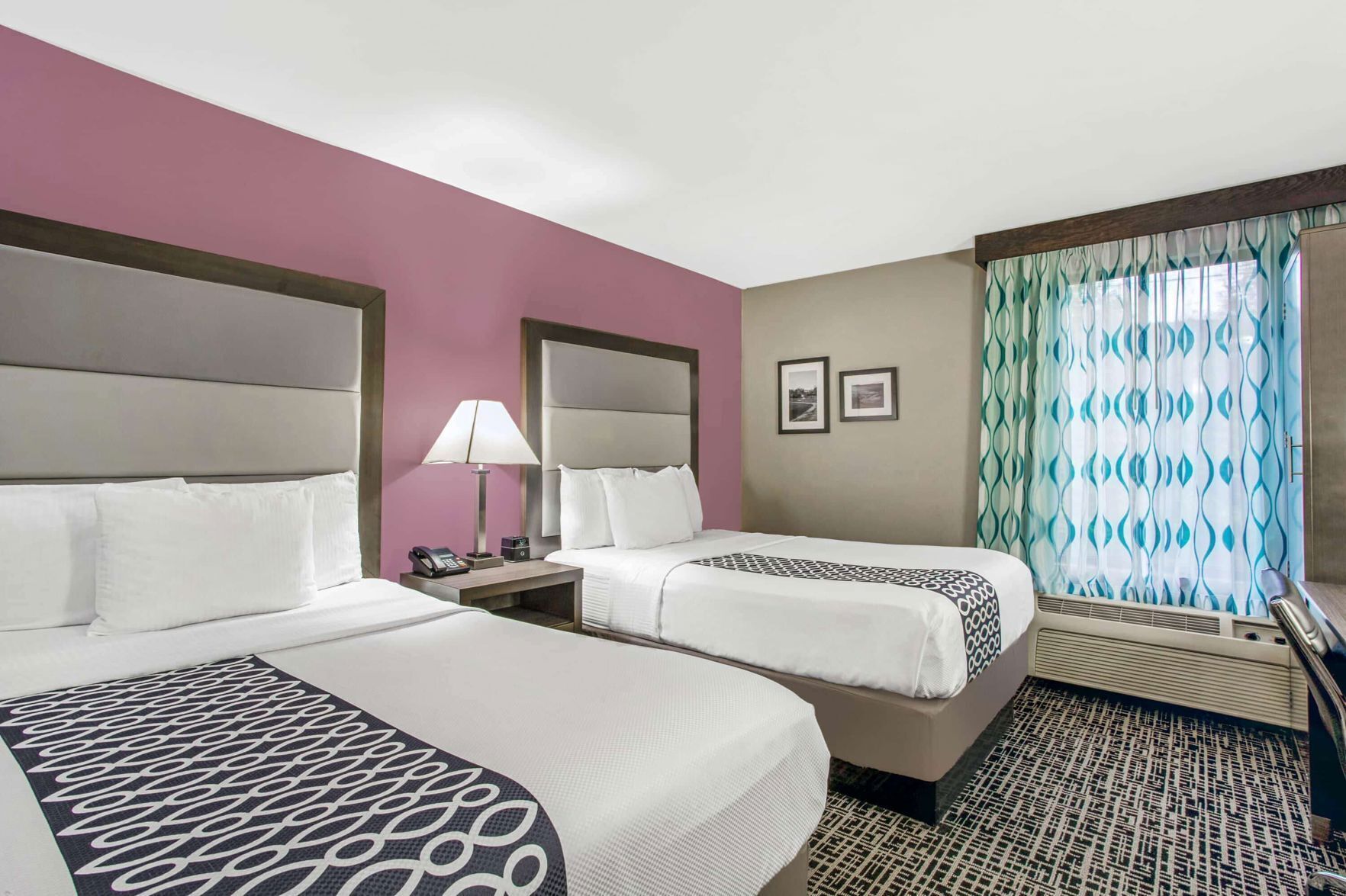 Premium bedding, desk, laptop workspace, blackout drapes