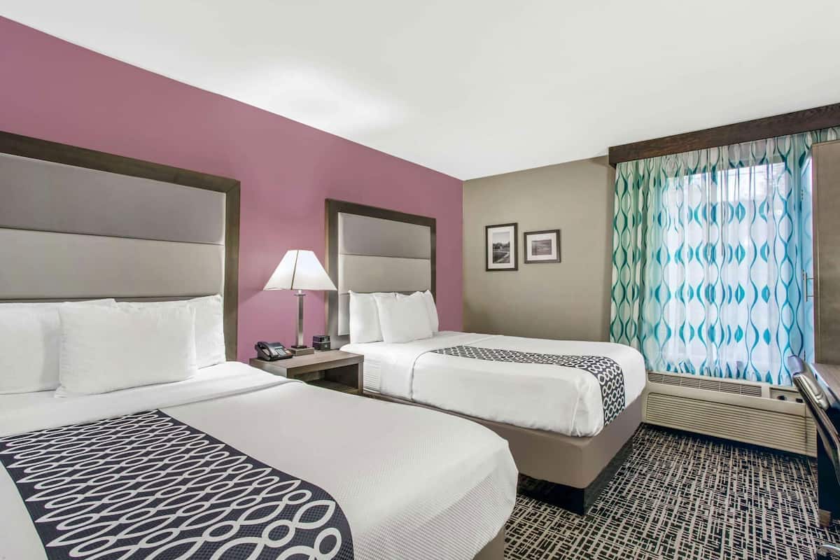 Premium bedding, desk, laptop workspace, blackout drapes