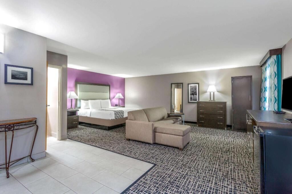 Premium bedding, desk, laptop workspace, blackout drapes