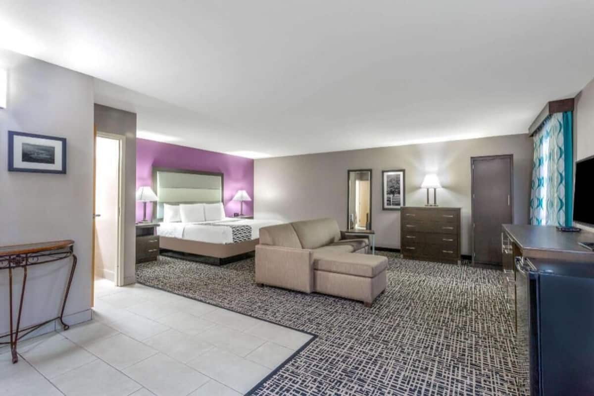 Premium bedding, desk, laptop workspace, blackout drapes