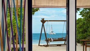 A beach view from a room with a swing set and a boat in the distance. - Dhawa Ihuru, part of Banyan Group – All inclusive with Free Transfer (Ihuru)