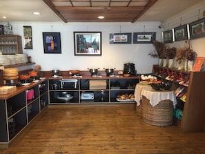 A kitchen with wooden cabinets, a dining table, and various kitchen utensils.