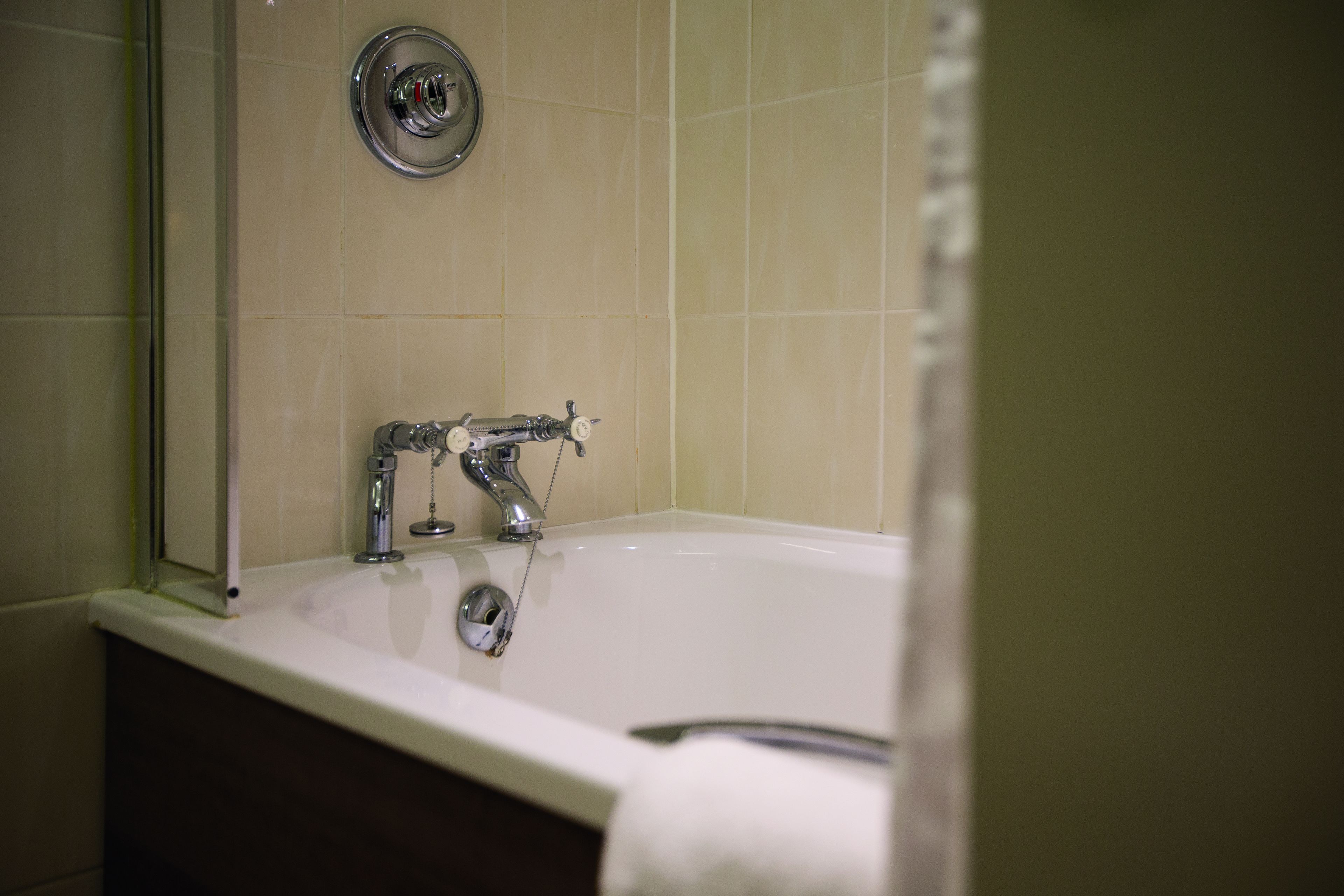 combined shower/bathtub, designer toiletries, hair dryer, bathrobes