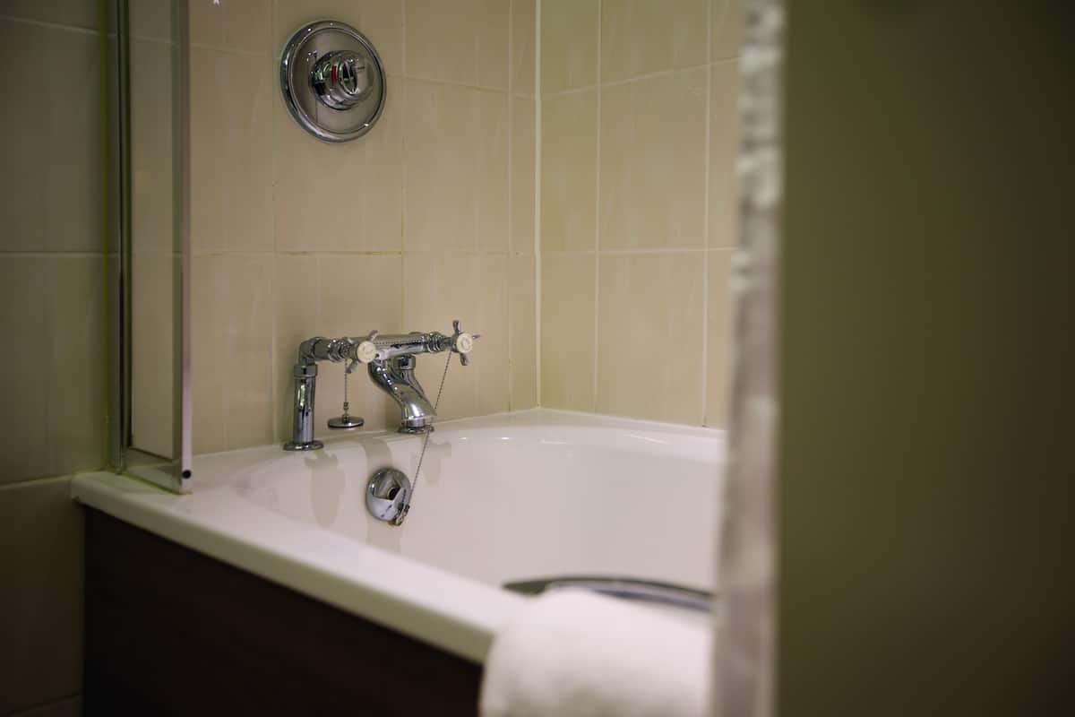 combined shower/bathtub, designer toiletries, hair dryer, bathrobes