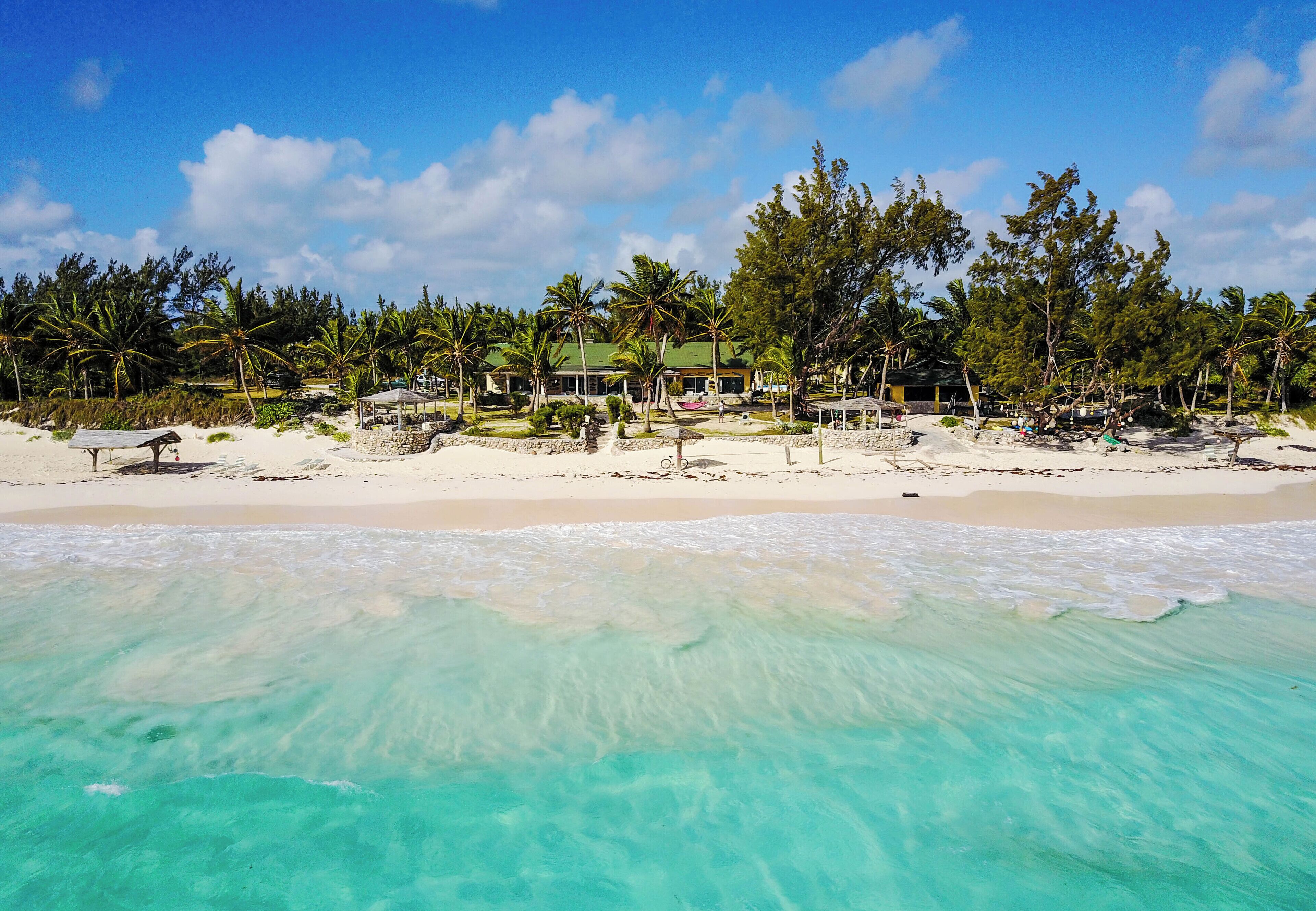 On the beach, white sand, sun loungers, beach towels