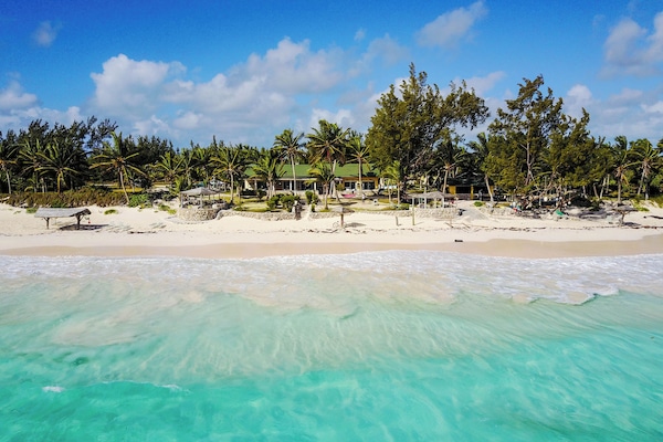 On the beach, white sand, sun loungers, beach towels