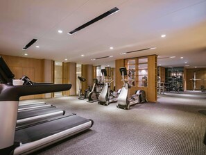 A modern gym with treadmills, elliptical machines, and weight equipment. - Pullman Shanghai Jing An (Shanghai)