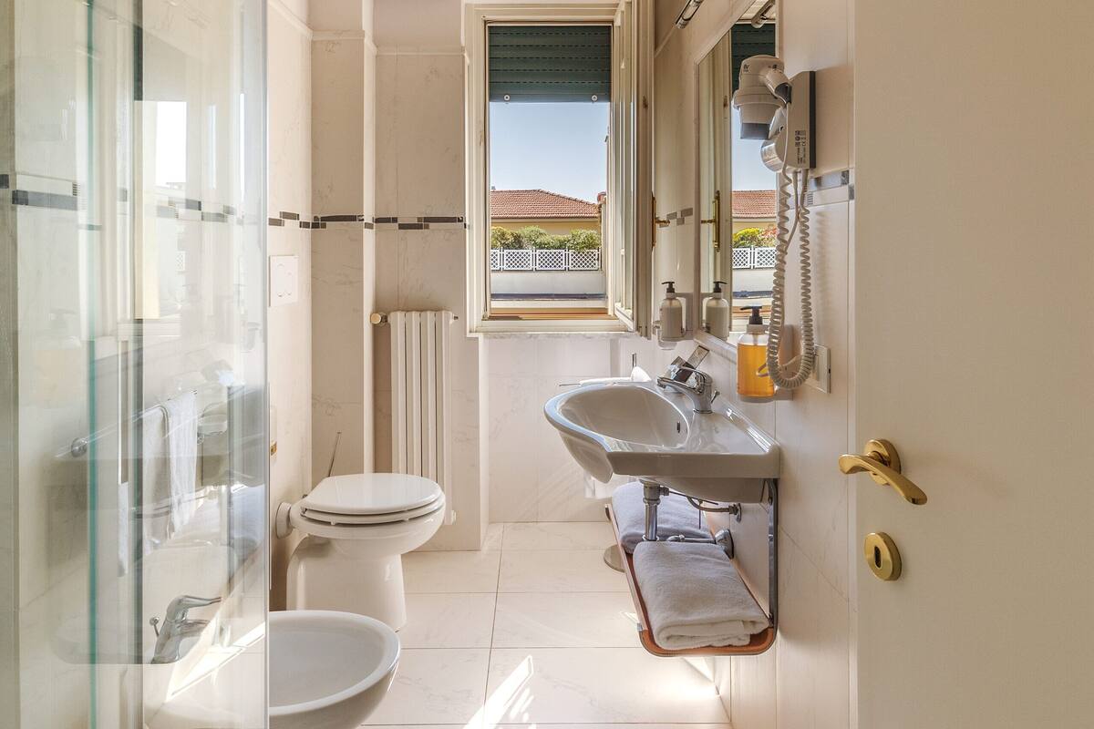 apartment with balcony | bathroom | designer toiletries, hair dryer, slippers, bidet