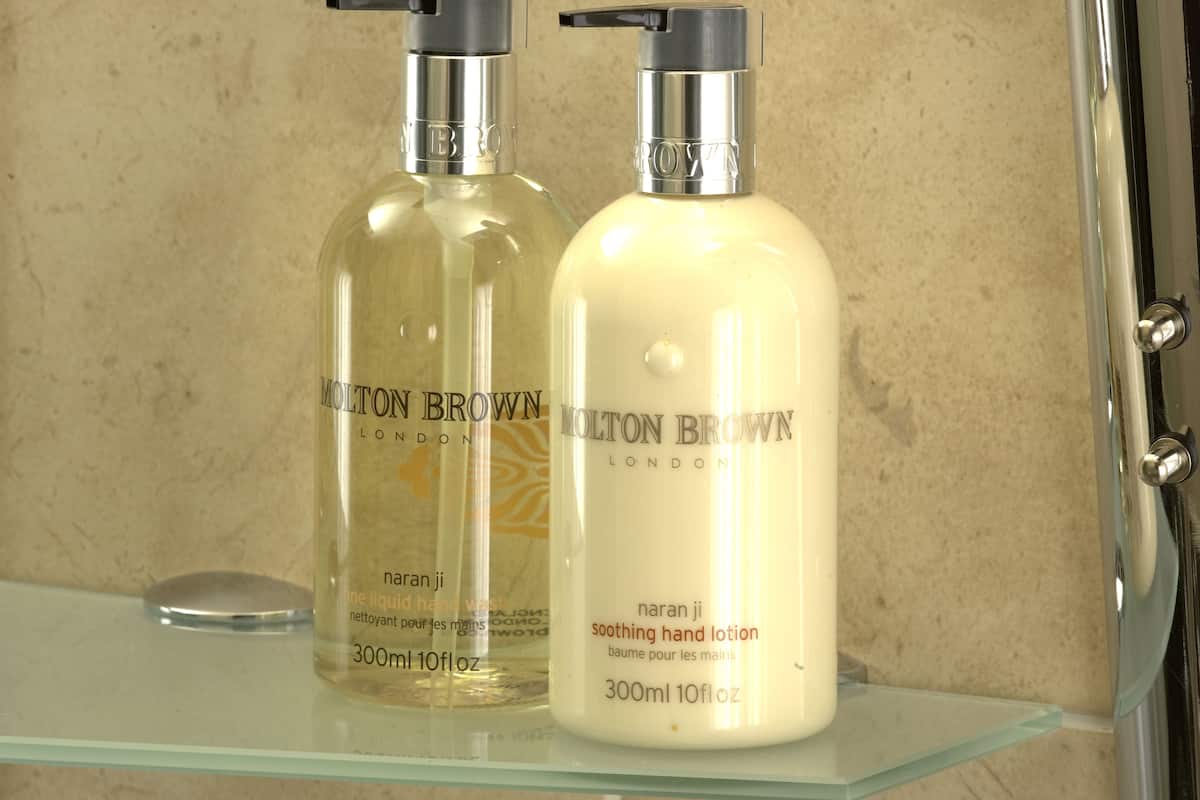 designer toiletries, hair dryer, towels, soap