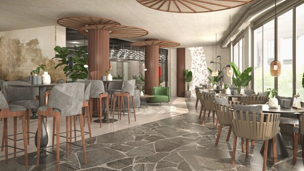 A modern interior with a mix of seating areas, including tables and chairs, and a stone-tiled floor.