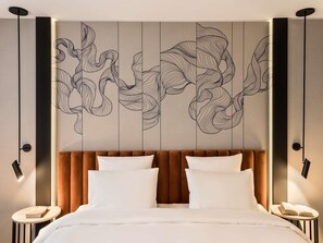 A modern hotel room with a large bed, two bedside tables, and a decorative wall panel. - Mercure Sofia City  (Sofia)