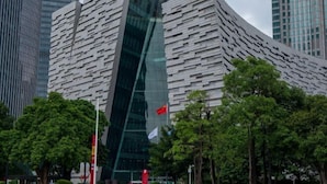 A modern building with a unique angular design, surrounded by trees and other high-rise buildings. - New TianHe Hotel (Guangzhou)