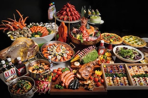 A variety of food items including seafood, meats, and vegetables, arranged on a table.
