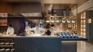 A modern kitchen with chefs at work, marble countertops, and a variety of kitchenware. - The Dragon Hotel (Hangzhou)